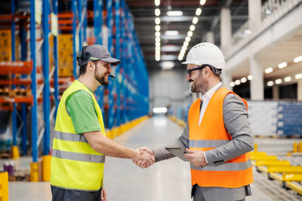 a storage worker shaking hands with supervisor. - manual worker handshake industry warehouse imagens e fotografias de stock