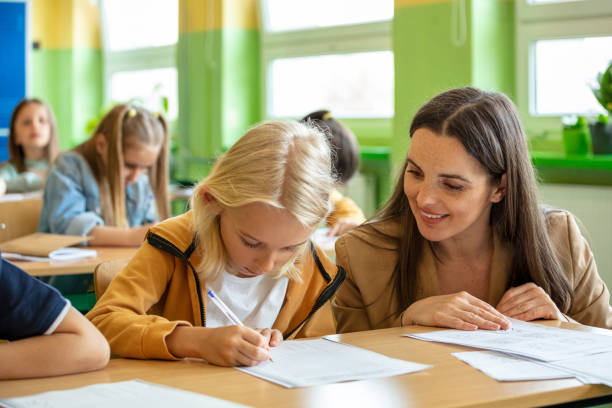 istock Female teacher talking with school boy 1447687772