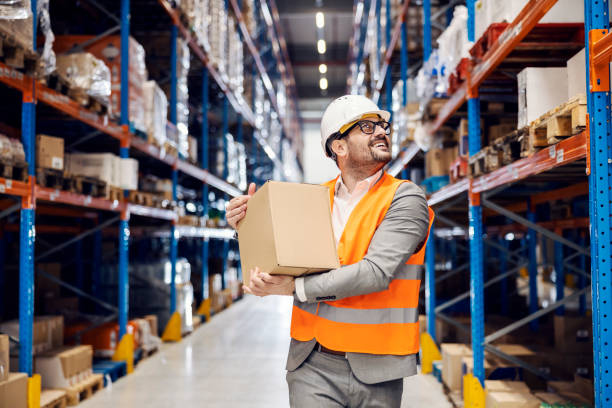 istock An inspector carries box with goods in storage. 1447687934