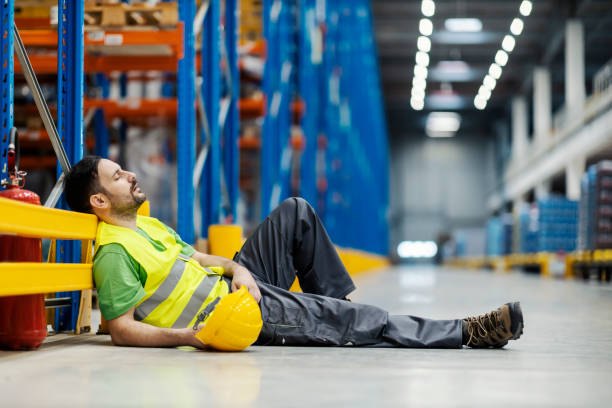 istock Lazy warehouse worker sleeping and snoring on the floor during work hours. 1447688464