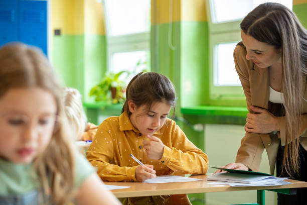 istock Schoolgirls learning in the classroom 1447689357