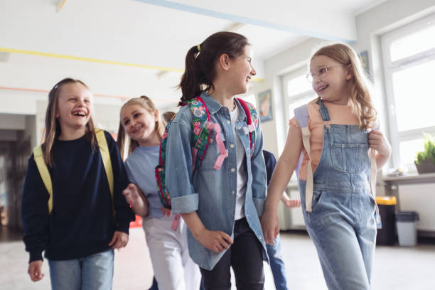 istock Schoolgirls walking the school corridor 1447689508
