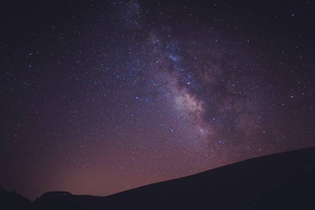 istock night sky with stars. Milky Way and Galaxy. long exposure shooting 1447691926