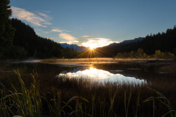 istock Sun reflection in the alpine pond 1447692450