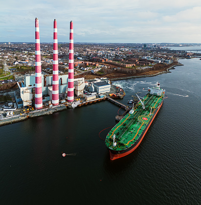 Aerial view of a crude oil tanker docked at a power generating station.