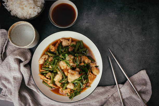 istock Top view Stir-fried pork and red hot curry paste with long bean and  Ingredients are oyster sauce, fish sauce, sugar, kaffir lime leaves in the dish Eat with cooked rice. Thai cuisine 1447694126