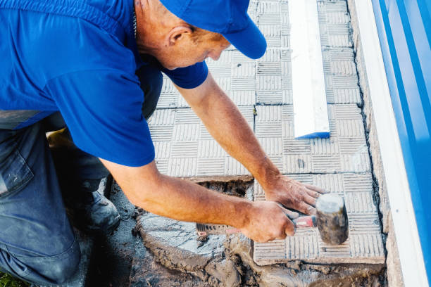 istock Bricklayer lays tiles. Professional builder in overalls and baseball cap at work. Elderly mason working outside. Close-up. 1447694143
