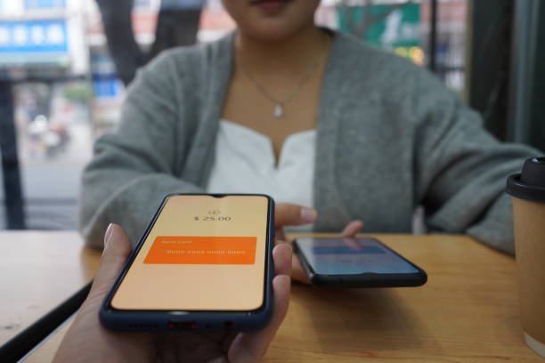istock Asian man using smartphone to transfer money 1447694267