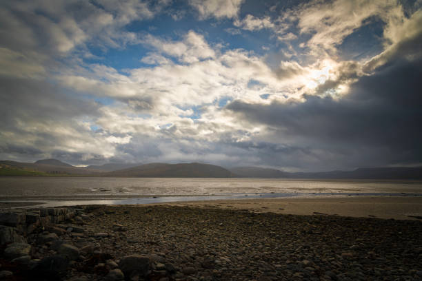 An autumnal HDR image of the Kyle of Tongue and surrounding mountains with a dramatic, atmospheric sky, Sutherland, Scotland.