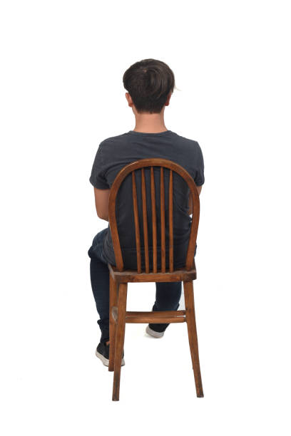 istock back view of adolescent sitting on chair 1447696450