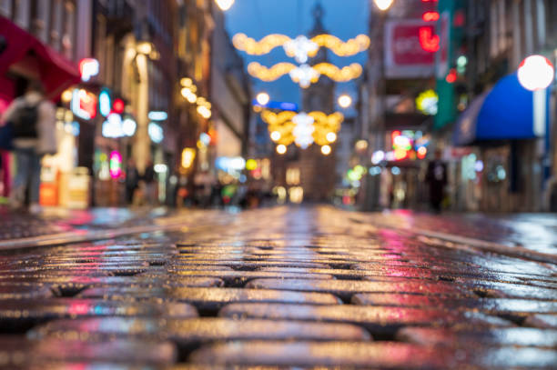 Amsterdam illuminated shopping street Reguliersbreestraat in the downtown district at night with christmas decorations over the Runstraat in the 9 straatjes shopping quarter.