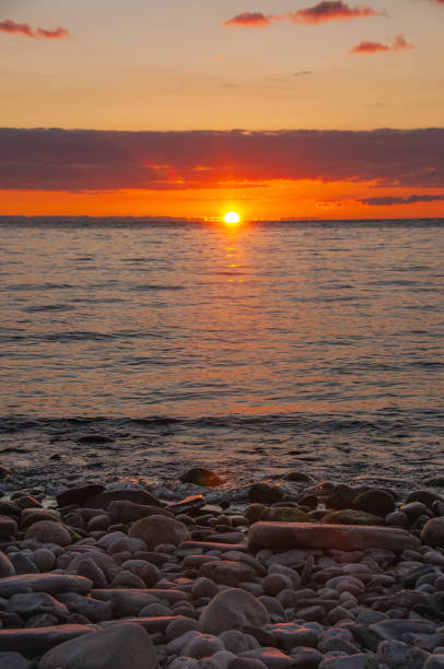 istock Sunrise with lake and rocks 1447700923