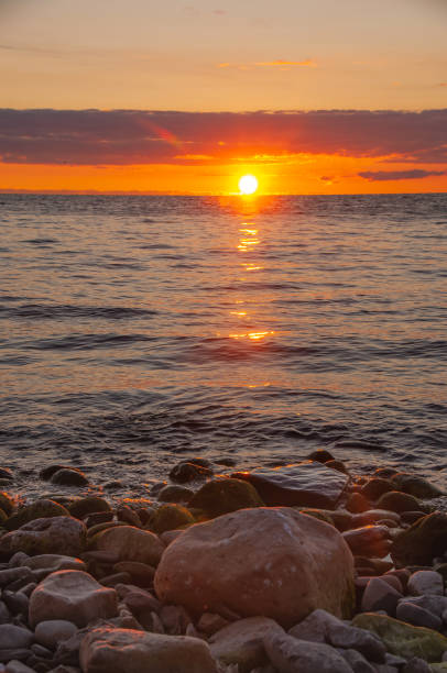 istock Sunrise with lake and rocks 1447700934