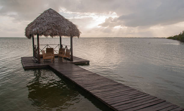 istock Beach hut and dock out onto the water 1447701761
