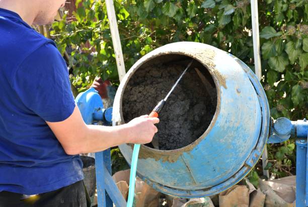 istock A bricklayer pours water into a concrete temperer at a construction site 1447702520