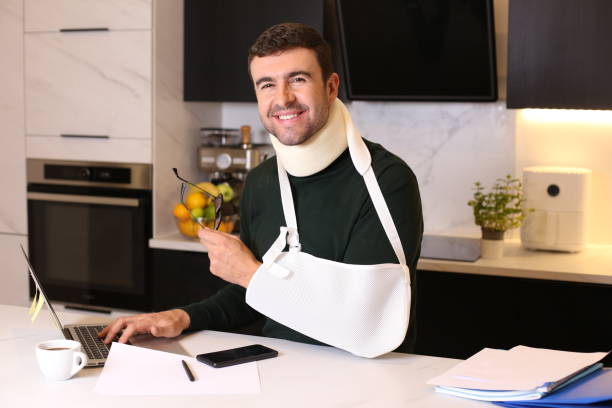 Worker doing home office after difficult accident stock photo
