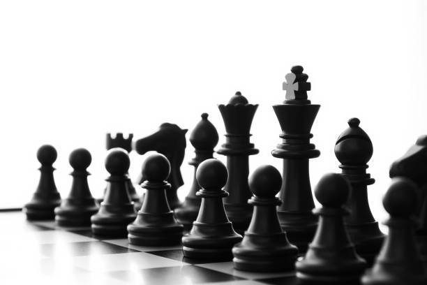 istock Isolated black Chess army ready for battle on a board with blurred perspective view 1447705242