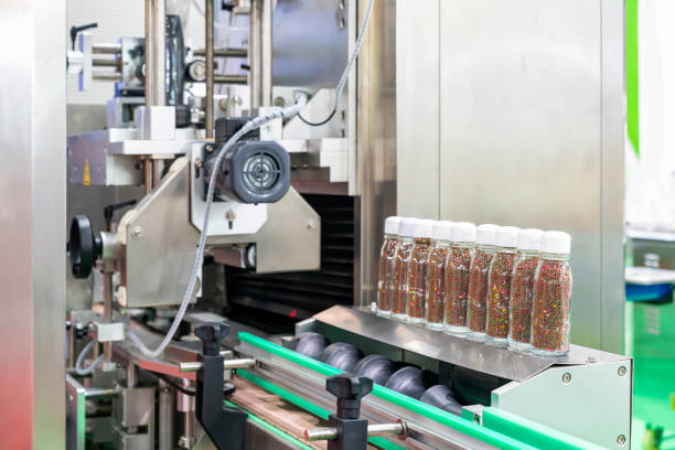 istock Small grain like product in transparent bottle glass are placed arrange row on automatic solid filling and capped machine in manufacturing process 1447706348
