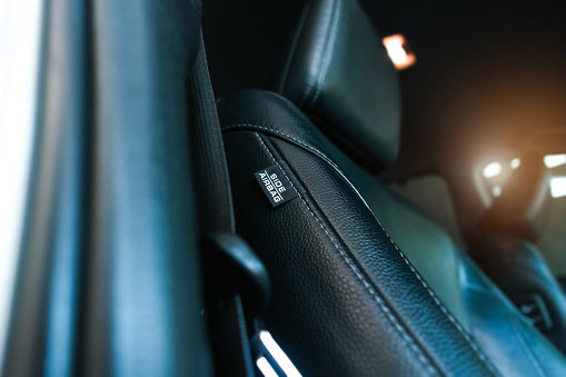 Airbag label on the side of the leather seat inside the car, Airbag system and car safety concept