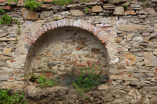 Old arch in a stone wall