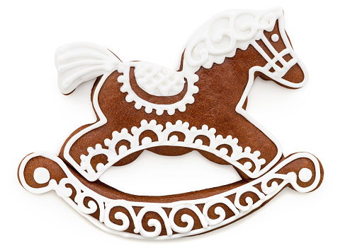 Gingerbread cookie with icing. \nHorse shape. \nIsolated on white.