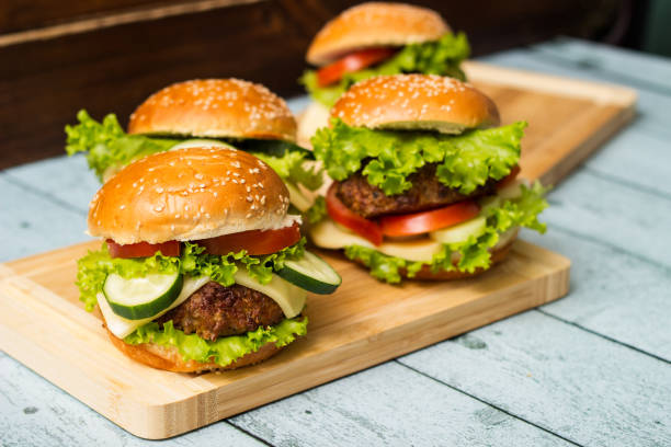 istock Fresh grilled burgers served on wood table 1447714478