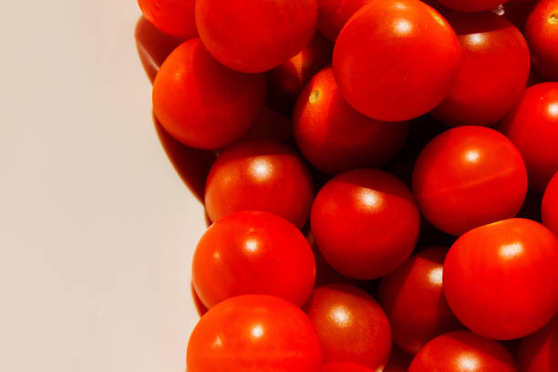 istock Cherry tomatoes. Cherry tomatoes close-up. Hard light. Bright light and shadow. 1447716200