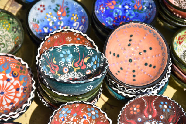 Colorful and patterned touristic gift bowls made of ceramic in a Turkish bazaar. Traditional oriental and ottoman culture patterned bowls
