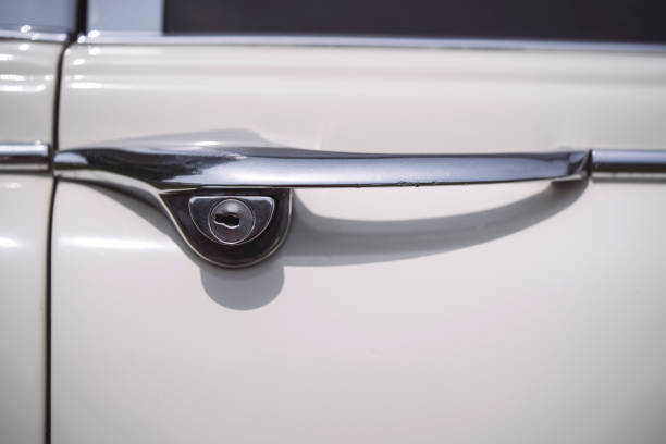 istock Vintage door handle of a white car 1447722656