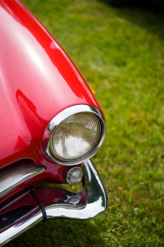 Color close up of a red vintage car headlight and turn signal.