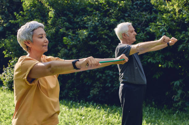 istock Senior couple doing exercises using resistance rubber bands 1447727818
