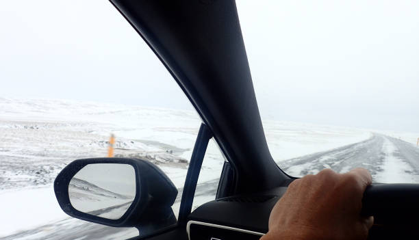 strada innevata da una macchina - rear view winter blizzard nordic countries foto e immagini stock