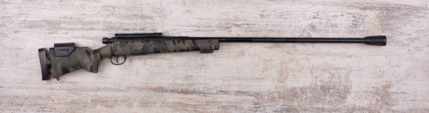 istock military rifle on old white wooden background 1447730730