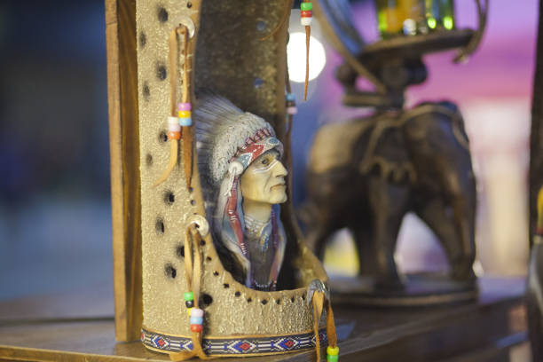 North american indigenous head with feathers sculpture at market stall on night market Huamum  in Bangkok Nawamin