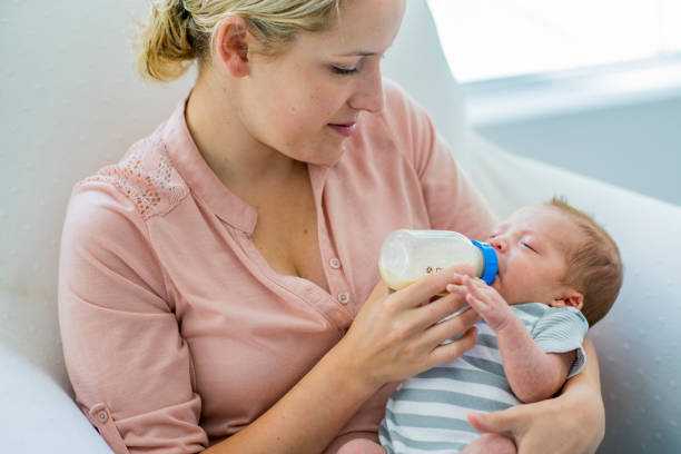 istock Mother Feeding her Newborn 1447734473