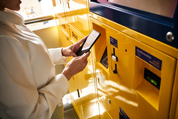 istock Digital nomad woman using phone making Contactless payments at public transportation ticket machine service. 1447744511