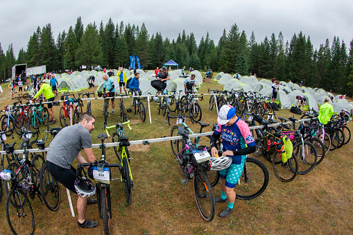 Riders prepare to compete in a stage of the 2022 TransRockies Gravel Royale race in British Columbia, Canada. The TransRockies Gravel Royale is a four-day gravel bicycle stage race that takes the participants on a selection of gravel roads, forestry and mining roads along with some sections of singletrack trail. Men, women and all age categories compete on the same course and take part in the mass start at the same time every day. Racers camp and sleep in tents along the way. Gravel bicycles are similar to road bicycles but have sturdy wheels and oversized tires for riding on rough terrain.  (John Gibson Photo/Gibson Pictures)