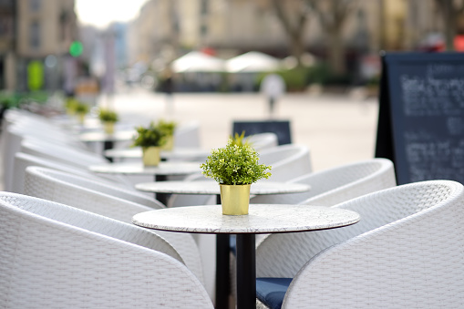 An empty stylish street cafe in a European city. Cozy outdoor restaurant. Off-season.