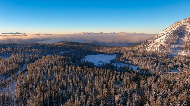 Aerial view of sunrise in the snow covered mountains stock photo