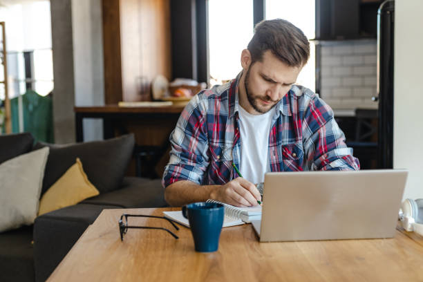 istock Young man working remotely at home. Online education 1447750518