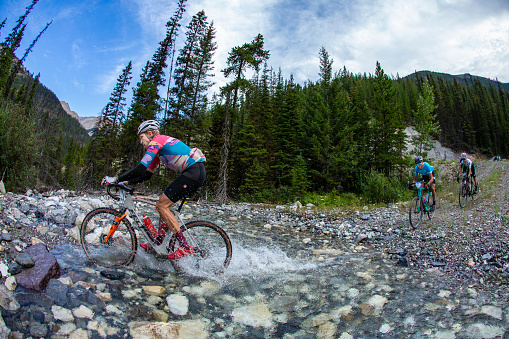The lead group of riders compete in the 2022 TransRockies Gravel Royale race in British Columbia, Canada. The TransRockies Gravel Royale is a four-day gravel bicycle stage race that takes the participants on a selection of gravel roads, forestry and mining roads along with some sections of singletrack trail. Men, women and all age categories compete on the same course and take part in the mass start at the same time every day. Gravel bicycles are similar to road bicycles but have sturdy wheels and oversized tires for riding on rough terrain.   (John Gibson Photo/Gibson Pictures)