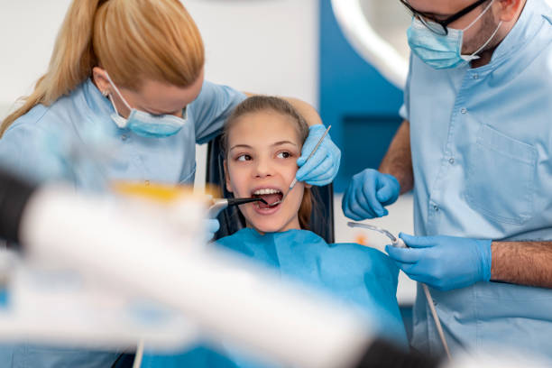 istock Female dentist checking patient teeth 1447754653