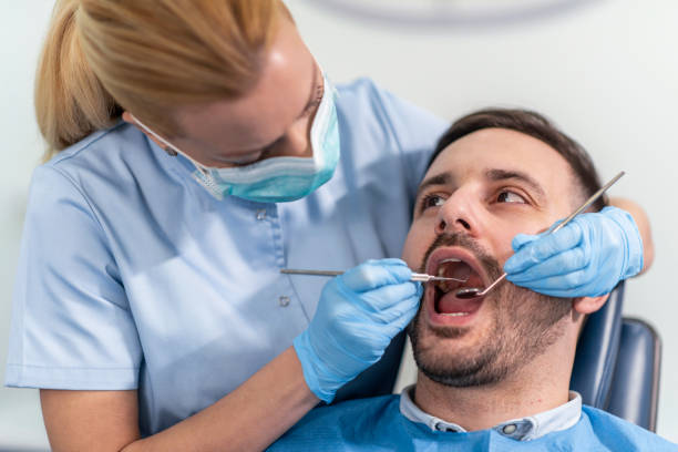 Female dentist repairing patient tooth in dental ambulant Woman dentist at work with patient.Dental care,taking care of teeth. ambulant patient stock pictures, royalty-free photos & images