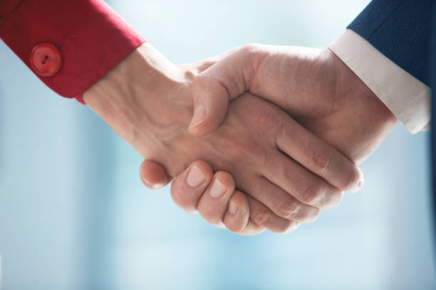 istock Emotional handshaking of two partners 1447759818