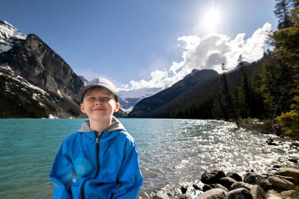 istock Young 6 years old redhead boy smiling and looking at the camera while hiking 1447764846