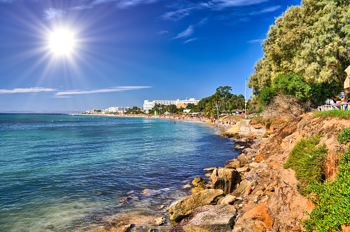 Sunny beach with swimming and bathing people, Hammamet, Tunisia, Mediterranean Sea, Africa, HDR