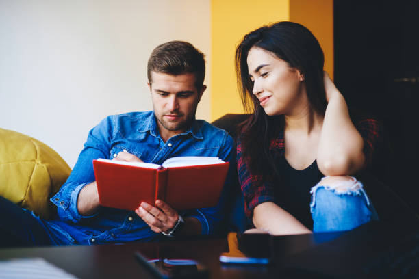 istock Young caucasian male and female student friends planning coursework project making notes, woman and man writing ideas for startup project cooperating and talking while sitting together indoors 1447765233