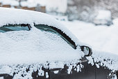 Car mirror close-up. Car under snow. Winter weather. Climate. Storm. Transportation
