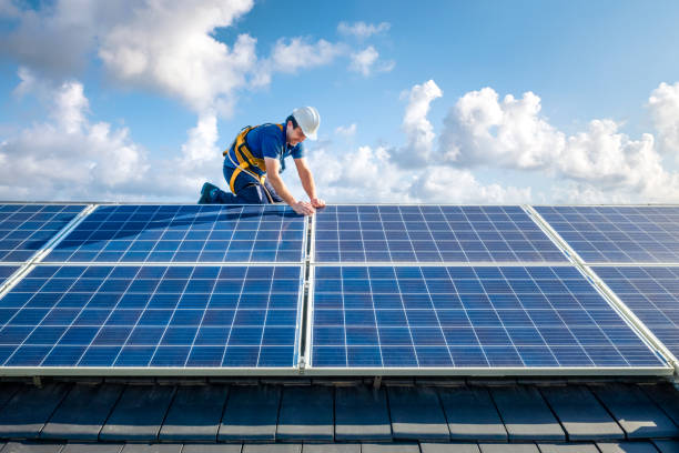 professional worker installing solar panels on the roof of a house - roof repairing tile construction imagens e fotografias de stock
