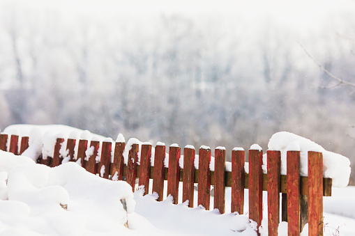 Snow on fence. Winter background. Copyspace. Weather. Climate